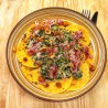 Ravioles aux aubergines et tomates confites, crémeux d'épinard, pancetta grillée et noisettes torréfiées